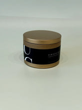Load image into Gallery viewer, Round gold tin candle with black label and hibiscus rain scent