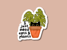 Load image into Gallery viewer, White sticker with cartoon plant pot containing green leaves and black cat eyes with text 'I just need cats &amp; plants'