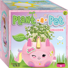Load image into Gallery viewer, Pink unicorn-shaped planter kit with chia sprouts growing from top, colorful packaging box