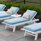 Load image into Gallery viewer, Light blue cushioned chaise loungers with white frames on a poolside patio