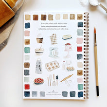 Load image into Gallery viewer, Spiral-bound watercolor workbook featuring baking illustrations and color palette swatches with paintbrush
