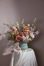 Load image into Gallery viewer, Teal ribbed ceramic vase holding a lush pastel floral arrangement on a white draped table