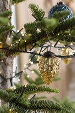 Load image into Gallery viewer, Gold mercury glass pinecone-shaped Christmas ornament hanging on decorated evergreen tree