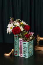 Load image into Gallery viewer, Triple book vase designed like stacked Grimm's fairy tale books holding mixed flower bouquet