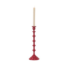 Load image into Gallery viewer, Red glossy ceramic candleholder with decorative ridged stem holding white taper candle