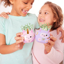 Load image into Gallery viewer, Two children holding cute animal-shaped planters with small plants growing from unicorn and cat containers