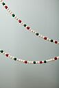 Load image into Gallery viewer, Festive Christmas candy garland featuring red, green, and white beaded decoration on gray background.