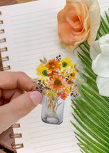 Load image into Gallery viewer, Clear vinyl sticker featuring watercolor wildflowers in glass mason jar on spiral notebook