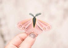 Load image into Gallery viewer, Hand holding pink butterfly vinyl sticker with feathered antennae and decorative wing patterns