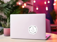 Load image into Gallery viewer, Humorous quote sticker with floral wreath design on laptop in colorful workspace