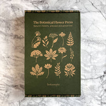 Load image into Gallery viewer, Green linen botanical flower press with gold foil plant illustrations on marble surface