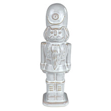 Load image into Gallery viewer, White ceramic nutcracker figurine with glazed finish and gold accent details