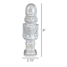 Load image into Gallery viewer, White ceramic nutcracker figurine, 9 inches tall, holiday seasonal decor piece