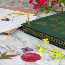Load image into Gallery viewer, Green linen flower press with gold foil botanical design and brass screw, surrounded by pressed flowers