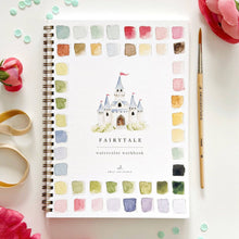 Load image into Gallery viewer, Spiral-bound fairytale watercolor workbook with castle illustration and color palette swatches