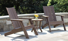 Load image into Gallery viewer, Two Madirondack chairs in heathered teak finish with round side table on stone patio