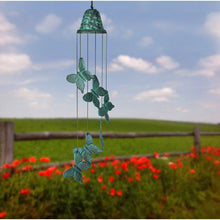 Load image into Gallery viewer, Green patina butterfly wind chime hanging outdoors with metal butterflies and bells