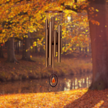 Load image into Gallery viewer, Bronze wind chime with multiple tubes and crystal accent hanging outdoors in autumn setting