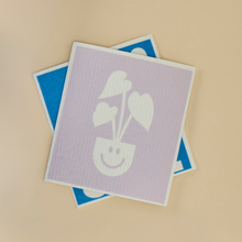 Load image into Gallery viewer, Two cleaning cloths with cute plant face designs in purple and blue colors