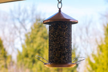 Load image into Gallery viewer, Copper-finished tube bird feeder with mesh metal design and protective cap hanging outdoors
