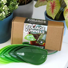 Load image into Gallery viewer, Green leaf-shaped watering funnels with product packaging displayed among potted plants