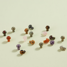 Load image into Gallery viewer, Collection of small decorative mushroom figurines in various gemstone colors scattered on white surface