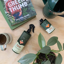 Load image into Gallery viewer, Plant care products including spray bottle and concentrate beside houseplant and gardening book