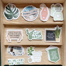 Load image into Gallery viewer, Collection of plant-themed vinyl stickers with quotes and botanical designs on wooden display