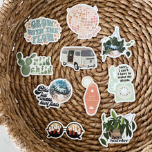 Load image into Gallery viewer, Collection of plant-themed vinyl stickers arranged on woven basket including disco balls and motivational quotes