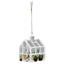 Load image into Gallery viewer, White glass greenhouse Christmas ornament with miniature plants and garden tools inside