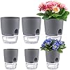 Load image into Gallery viewer, Six gray self-watering plant pots in two rows, some containing colorful flowering plants