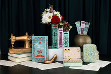 Load image into Gallery viewer, Triple book vase set with fairy tale covers displaying fresh flowers in vintage-styled arrangement