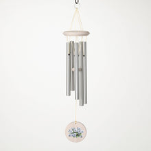 Load image into Gallery viewer, Wind chime with silver tubes and purple pansy decorative disc hanging outdoors