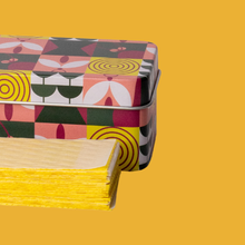 Load image into Gallery viewer, Yellow sticky trap sheets emerging from colorful geometric patterned tin storage box