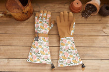 Load image into Gallery viewer, Floral patterned gardening gloves with extended arm protection on wooden surface with terracotta pots