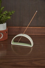 Load image into Gallery viewer, Modern ceramic incense holder with white exterior and green interior holding burning incense stick