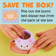 Load image into Gallery viewer, Hands planting seeds in cute purple bunny-shaped planter with display mat underneath