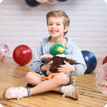 Load image into Gallery viewer, Happy child holding green and brown mallard duck plush toy in playroom setting
