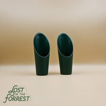 Load image into Gallery viewer, Two dark green ceramic or plastic soil scoops with angled openings on neutral background