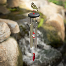 Load image into Gallery viewer, Wind chime with silver tubes, red accents, and decorative cardinal bird topper hanging outdoors