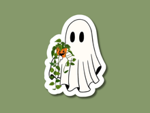Load image into Gallery viewer, White ghost sticker holding trailing pothos plant with orange jack-o-lantern pot on green background