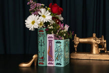 Load image into Gallery viewer, Triple book vase with fairy tale designs holding colorful flowers on decorative table