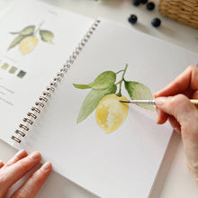 Load image into Gallery viewer, Hand painting watercolor lemon with leaves in spiral-bound art workbook using fine brush