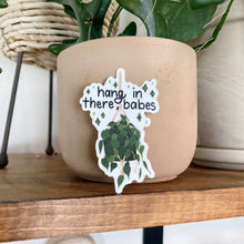 Load image into Gallery viewer, Hang In There Babes sticker with hanging plant design on terracotta pot