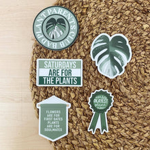 Load image into Gallery viewer, Collection of green plant-themed stickers on woven basket including monstera leaf and plant quotes
