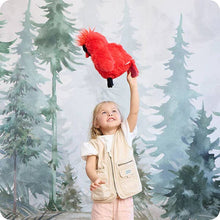 Load image into Gallery viewer, Young girl holding red cardinal plush toy with forest backdrop