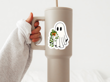 Load image into Gallery viewer, Hand holding beige tumbler with cute ghost holding pothos plant sticker