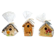 Load image into Gallery viewer, Three decorative birdhouses covered in birdseed with colorful flowers, wrapped in clear cellophane packaging