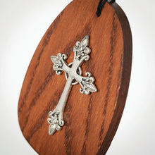 Load image into Gallery viewer, Wooden wind chime with ornate silver cross and decorative floral elements on oval base