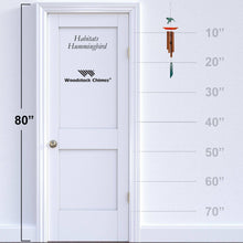 Load image into Gallery viewer, Woodstock Chimes Habitats Hummingbird wind chime with copper tubes and red feeder attachment shown with size scale